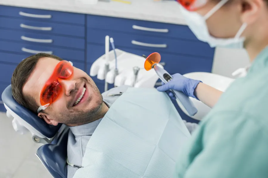 tooth whitening gastonia nc treatment smiling man with red sunglasses in dental office