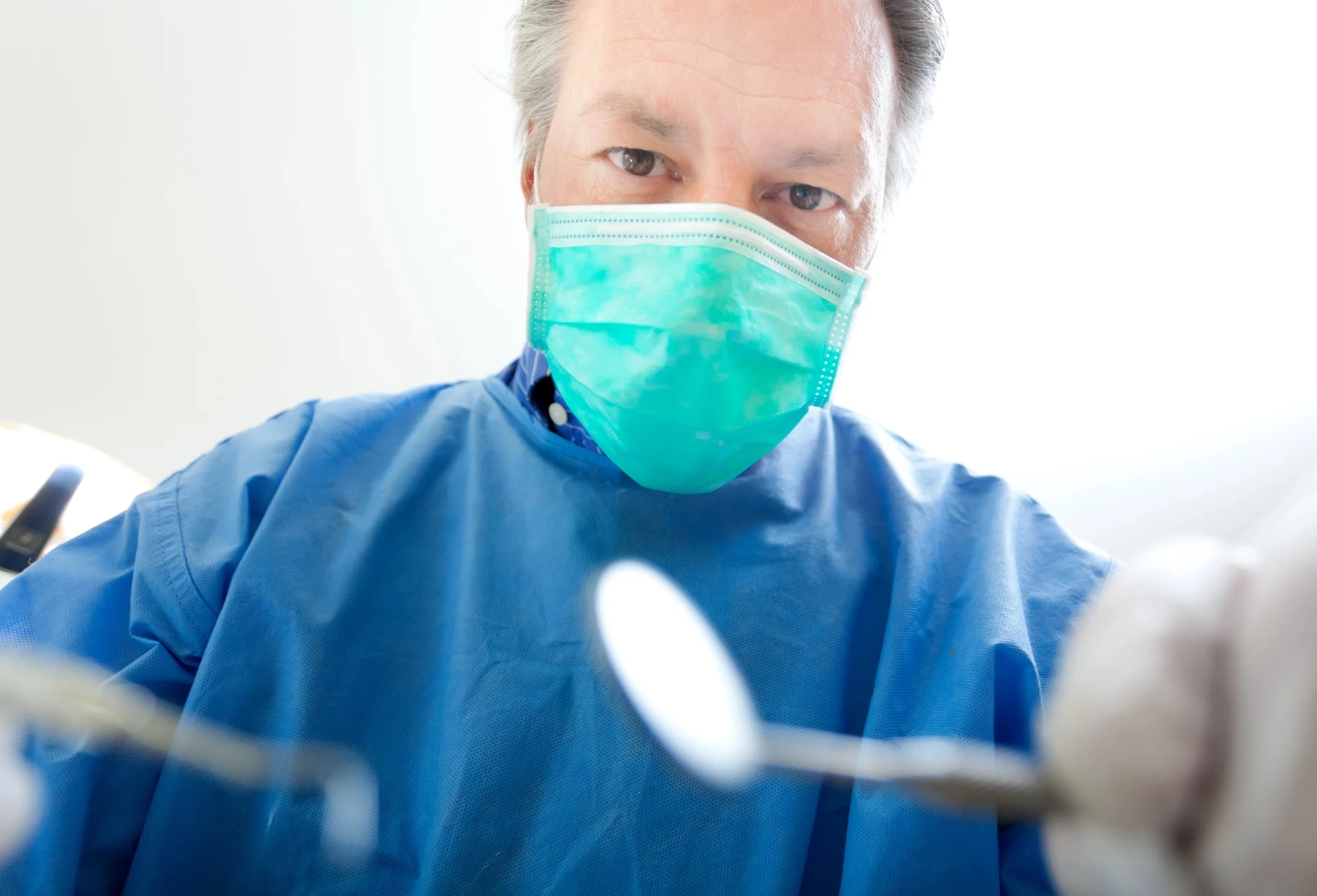 dentist-gastonia-nc-providing-dental-care-with-masked-dentist-during-procedure