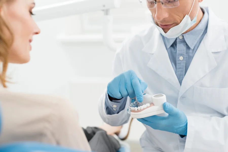 dentists in huntersville nc explaining treatment options with dental model