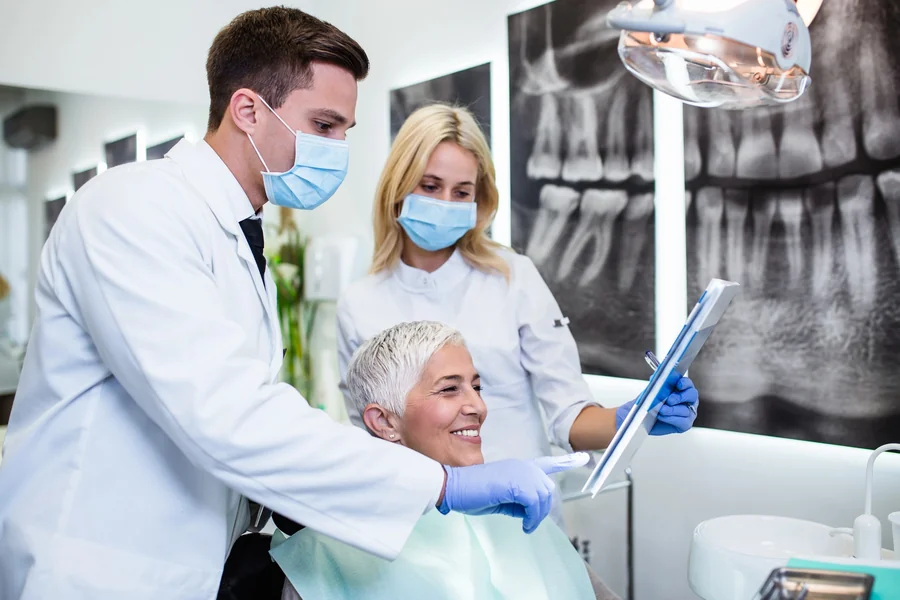 dentists in huntersville nc reviewing digital xrays with senior patient