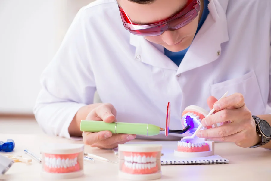 affordable dentures huntersville nc technician curing denture with light