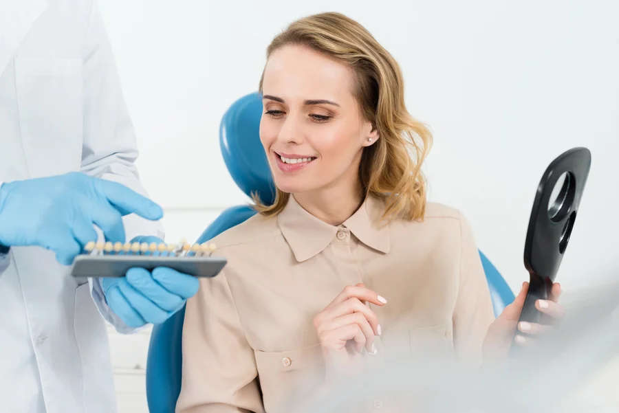 dental-implants-park-road-charlotte-nc-patient-checking-smile-in-mirror