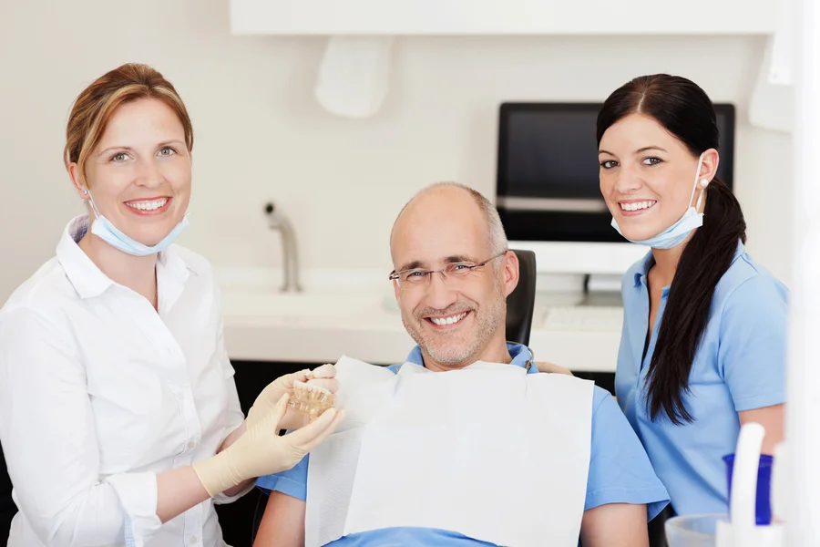 dental-implants-park-road-charlotte-nc-team-with-happy-patient