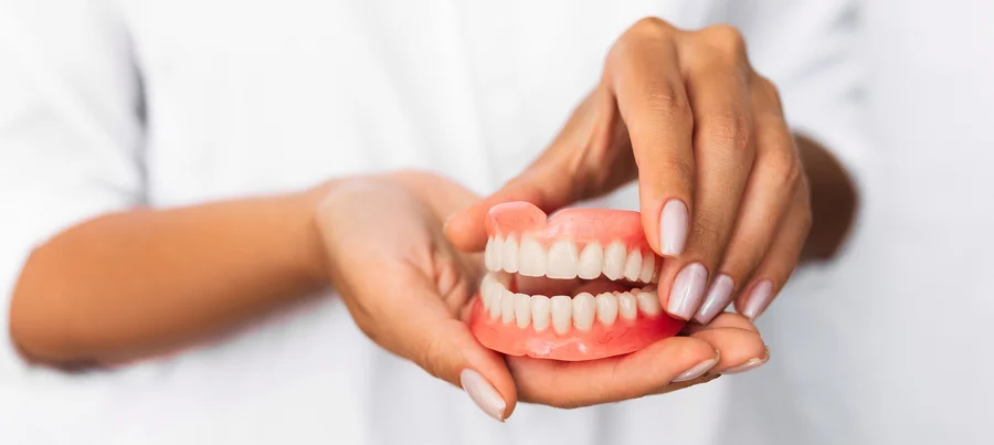 dentures in hickory nc hands holding full upper and lower denture