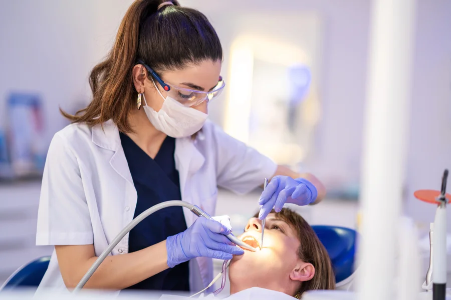 dentist performing root canal treatment in huntersville nc on a patient in the chair