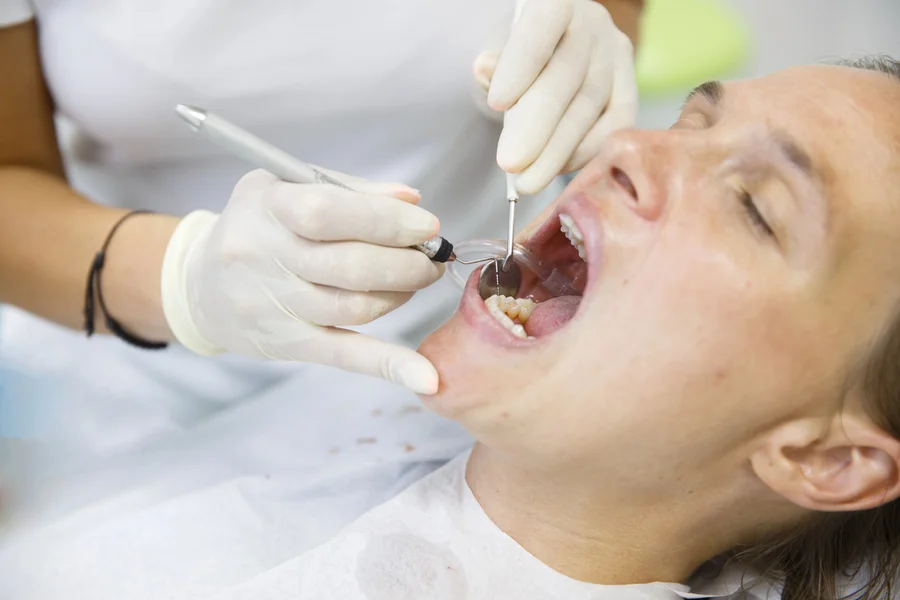 tooth extraction huntersville nc close up of dentist examining a patient s open mouth