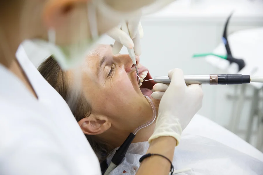 tooth extraction huntersville nc patient reclined while dentist works with dental tools